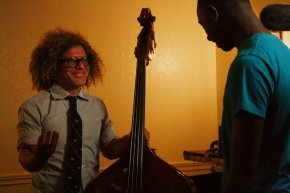 Ben Jaffe, imaginative director for the Preservation Hall Jazz Band, offers Justin, fifteen, a lesson regarding the bass.